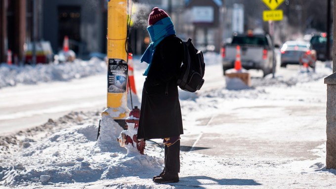 Bundled in layers of warm clothing, a pedestrian in Minneapolis braves a freezing day